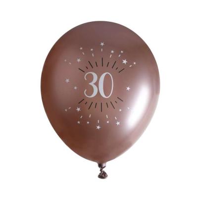 6 Ballons anniversaire en latex de 30 cm, fond rose gold avec le chiffre 30 entouré de points et étoiles coloris blanc.