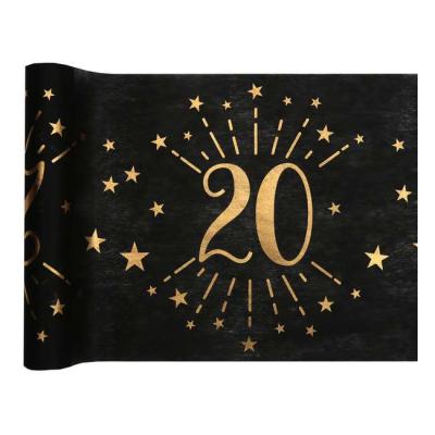 5 Mètres chemin de table anniversaire 20 ans en intissé, fond noir, impression du chiffre 20 et d'étoiles coloris or métallisé.