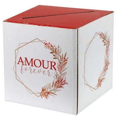 Une urne tirelire de 20 cm x 20 cm, livré à plat, avec en décor des feuillages et l'inscription Amour forever dans les tons blanc, terracota, rose poudré
